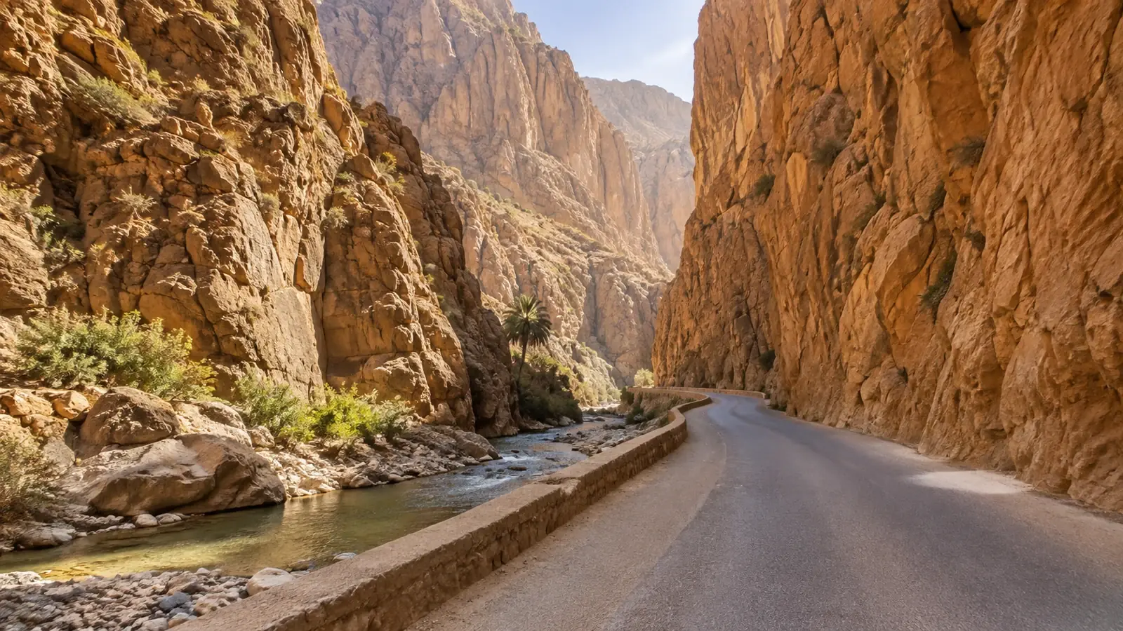 A paved road between tall ochre canyon walls
