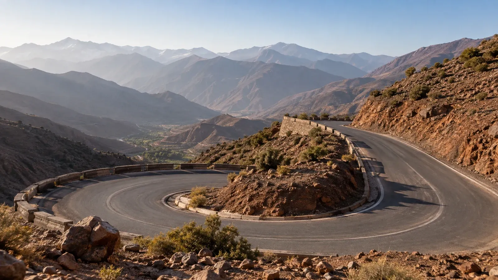 A winding paved road across dry mountain slopes