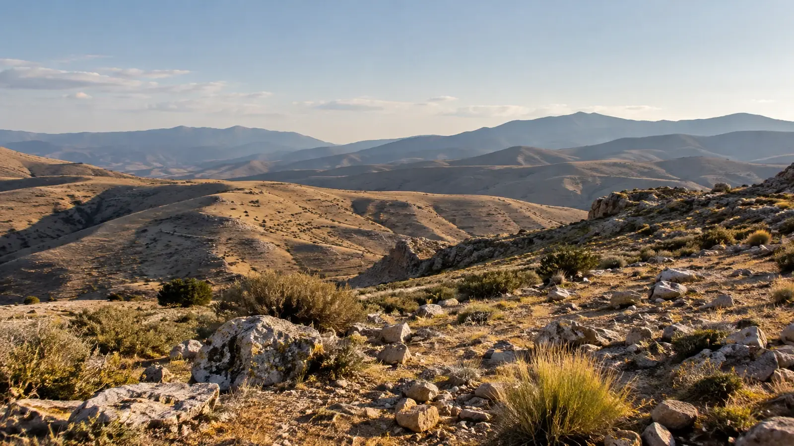 A rocky plateau with distant mountain silhouettes